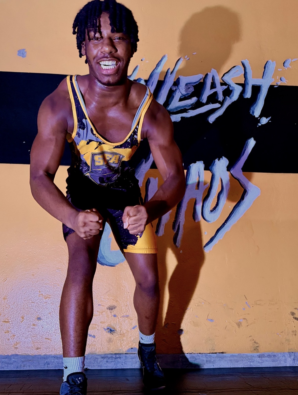 St. Francis wrestler in a ready stance wearing an SFA singlet